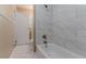 Bathroom features a white tub, white tiled walls, toilet and access to another room at 881 Mercury Nw Dr, Atlanta, GA 30331
