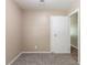 The bedroom features neutral walls, carpeted floor, and a door to another room at 881 Mercury Nw Dr, Atlanta, GA 30331