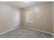 Neutral bedroom features carpeted floor, white trim, a window, and freshly painted walls at 881 Mercury Nw Dr, Atlanta, GA 30331