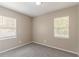 Neutral bedroom features carpeted floor, white trim, two windows, and freshly painted walls at 881 Mercury Nw Dr, Atlanta, GA 30331