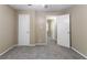 This bedroom has neutral colored walls and carpeted floors with white doors and trim at 881 Mercury Nw Dr, Atlanta, GA 30331