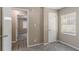 Bedroom features neutral walls, carpet, a window and access to another room at 881 Mercury Nw Dr, Atlanta, GA 30331