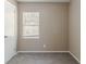 Neutral bedroom features carpeted floor, white trim, a window, and freshly painted walls at 881 Mercury Nw Dr, Atlanta, GA 30331
