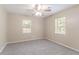 This bedroom has two windows that provide natural light and neutral colored walls with a ceiling fan at 881 Mercury Nw Dr, Atlanta, GA 30331
