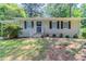 Charming single-story home with neutral siding, black shutters, and a welcoming front porch at 881 Mercury Nw Dr, Atlanta, GA 30331