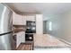 Kitchen with stainless steel appliances, white cabinetry, and a functional island at 881 Mercury Nw Dr, Atlanta, GA 30331