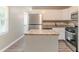 Modern kitchen with stainless steel appliances, white cabinets, and an island at 881 Mercury Nw Dr, Atlanta, GA 30331