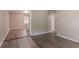 Spacious living room with wood flooring leads into kitchen with white cabinets and countertops at 881 Mercury Nw Dr, Atlanta, GA 30331