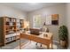 Bright office features built-in bookshelves, wooden desk, neutral walls and area rug at 881 Mercury Nw Dr, Atlanta, GA 30331