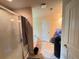 Bright bathroom with a tiled shower, soaker tub, and light beige walls, filled with natural light at 12351 Styron Dr, Hampton, GA 30228
