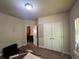 Bedroom featuring carpet, neutral walls, and a closet under the light of a ceiling light at 12351 Styron Dr, Hampton, GA 30228
