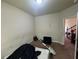 A view of the bedroom with fair lighting, an unmade bed and doorway leading to stairs at 12351 Styron Dr, Hampton, GA 30228