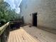 An exterior view of the wood paneled deck adjacent to a brick exterior wall at 12351 Styron Dr, Hampton, GA 30228