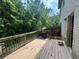 An exterior view of the wood paneled deck surrounded by lush greenery at 12351 Styron Dr, Hampton, GA 30228