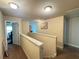 Hallway with neutral walls, carpet, and an open doorway to another room, under the light of ceiling lights at 12351 Styron Dr, Hampton, GA 30228