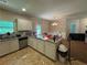 Spacious kitchen featuring modern appliances, granite countertops, and a breakfast bar at 12351 Styron Dr, Hampton, GA 30228