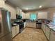 Bright kitchen with stainless steel appliances, granite countertops, and ample cabinet space at 12351 Styron Dr, Hampton, GA 30228