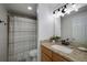 Well-lit bathroom with a shower, granite vanity top, and contemporary finishes at 1445 Monroe Ne Dr # C13, Atlanta, GA 30324