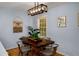 Inviting dining area featuring a wooden table, modern chandelier, and a window for natural light at 1445 Monroe Ne Dr # C13, Atlanta, GA 30324