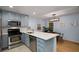 Bright eat-in kitchen features stainless steel appliances, quartz countertops, and decorative pendant lighting at 1445 Monroe Ne Dr # C13, Atlanta, GA 30324