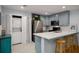 Well-lit kitchen features stainless steel appliances, a breakfast bar, and adjacent washer and dryer at 1445 Monroe Ne Dr # C13, Atlanta, GA 30324