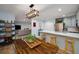 Open kitchen and dining area with stainless steel appliances, breakfast bar, and a wooden dining table at 1445 Monroe Ne Dr # C13, Atlanta, GA 30324