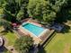 Aerial view of a sparkling pool surrounded by lush greenery and lounge chairs at 1445 Monroe Ne Dr # C13, Atlanta, GA 30324