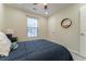 Comfortable bedroom includes a ceiling fan, window, and a cozy bed with storage nearby at 2125 Jessica Way, Lithonia, GA 30058
