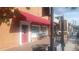 Exterior view of a commercial building with a red awning, benches, and retail signage at 2125 Jessica Way, Lithonia, GA 30058
