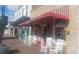 Exterior view of commercial storefront with red awnings, rocking chairs, and retail signage at 2125 Jessica Way, Lithonia, GA 30058