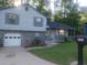 Charming two-story home with a stone facade, attached garage and well-manicured front yard at 2125 Jessica Way, Lithonia, GA 30058