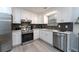 Modern kitchen featuring stainless steel appliances, white cabinets, and sleek countertops at 2125 Jessica Way, Lithonia, GA 30058