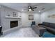 Cozy living room with stone fireplace, ceiling fan, and bright overhead lighting at 2125 Jessica Way, Lithonia, GA 30058
