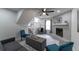Comfortable living room features a stone fireplace, a ceiling fan, and stairway access at 2125 Jessica Way, Lithonia, GA 30058
