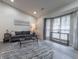 Elegant living room featuring a vaulted ceiling, plush seating, and ample natural light from large windows at 2125 Jessica Way, Lithonia, GA 30058