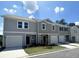 Modern townhome exteriors featuring neutral siding, attached garages, and well-maintained landscaping at 311 Winton Way, Villa Rica, GA 30180