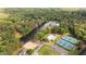 Aerial view featuring a lake, community pool, and tennis courts, showcasing the neighborhood's amenities at 3390 River Ferry Dr, Alpharetta, GA 30022