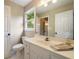 Bright bathroom features a vanity with a white countertop, and a large mirror, creating a fresh and inviting space at 3390 River Ferry Dr, Alpharetta, GA 30022