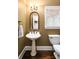 Charming bathroom boasts a pedestal sink, classic finishes, and a view to a tiled shower area at 3390 River Ferry Dr, Alpharetta, GA 30022