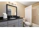 Bright bathroom with a vanity, toilet, and shower-tub combo with a white curtain at 3390 River Ferry Dr, Alpharetta, GA 30022