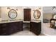 Bathroom with dual vanities, granite countertops, and dark wood cabinetry at 3390 River Ferry Dr, Alpharetta, GA 30022