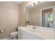Well-lit bathroom features a large mirror, white vanity, and a view of the modern tiled shower beyond at 3390 River Ferry Dr, Alpharetta, GA 30022
