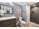 Updated bathroom with a modern vanity, toilet, and a walk-in tile shower at 3390 River Ferry Dr, Alpharetta, GA 30022