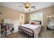 Cozy bedroom with a ceiling fan, desk, and ample natural light at 3390 River Ferry Dr, Alpharetta, GA 30022