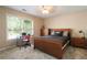 Cozy bedroom with a large window, desk, ceiling fan and a comfortable bed, perfect for relaxation at 3390 River Ferry Dr, Alpharetta, GA 30022