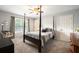 Well-lit bedroom with neutral carpet, and a ceiling fan at 3390 River Ferry Dr, Alpharetta, GA 30022