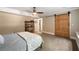 Bedroom features a sliding barn door, ceiling fan, and neutral wall paint at 3390 River Ferry Dr, Alpharetta, GA 30022