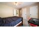 Bedroom with a bed, desk and bathroom access showing a flexible layout perfect for a home office or guest room at 3390 River Ferry Dr, Alpharetta, GA 30022