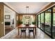 Bright dining room with modern light fixture and sliding glass doors leading to an outdoor porch at 3390 River Ferry Dr, Alpharetta, GA 30022