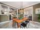 Open dining room leading to other rooms of the home featuring a modern light fixture and tile floors at 3390 River Ferry Dr, Alpharetta, GA 30022